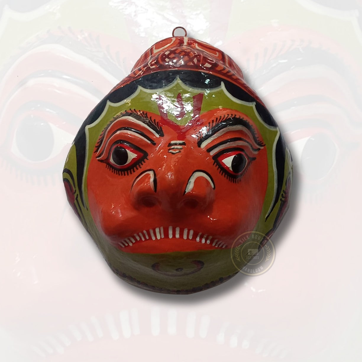 Bring home the charm of Odisha, buy it now, with this red and green handicraft hand-painted face mask.